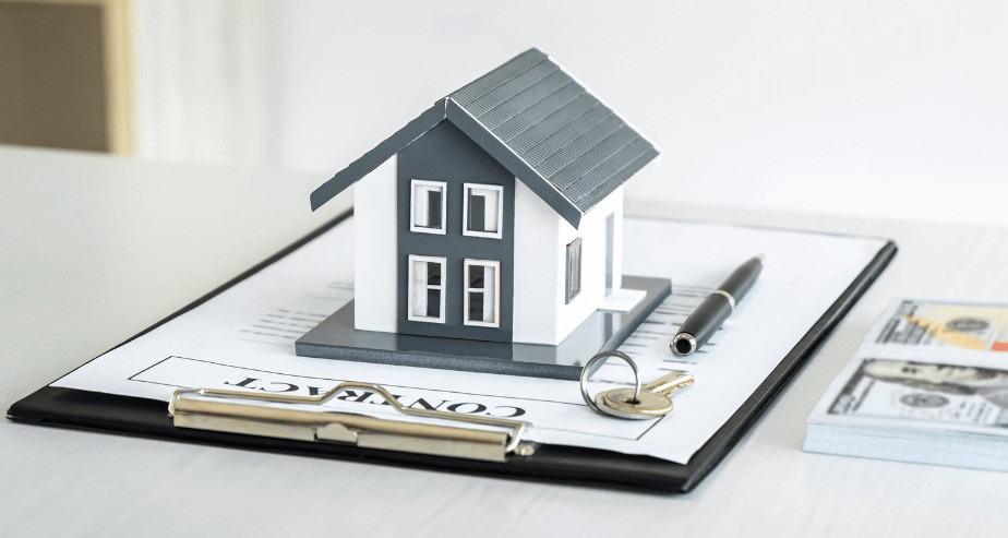 Real estate mortgage and house buying concept with house model, contract, and money.